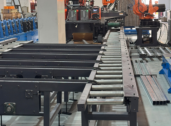Automatic roller conveyor system transporting rack beams to the robotic welding station